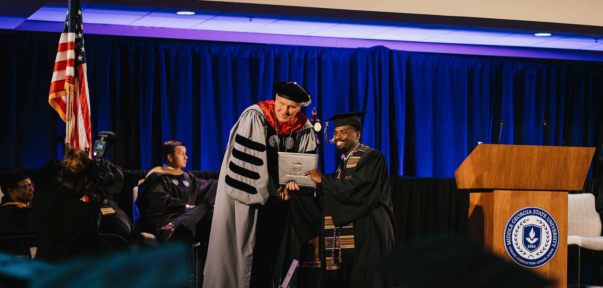 President Blake handing out diplomas at fall 2023 graduation.