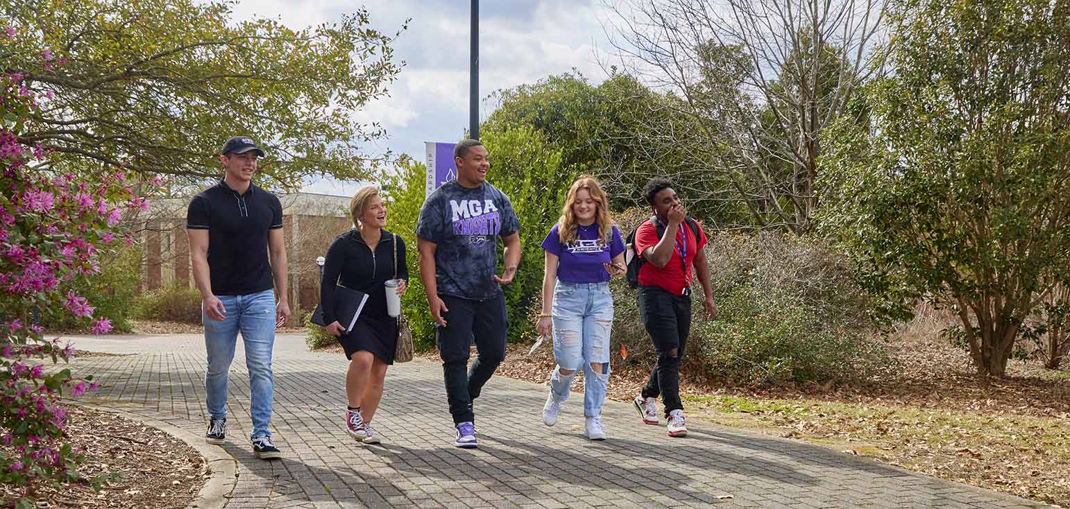 MGA students walk and talk across the Macon Campus. 
