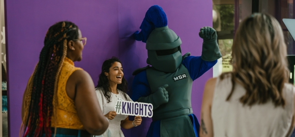 Students pose for a photo with Duke at Stuff-a-Friend on the Macon Campus.